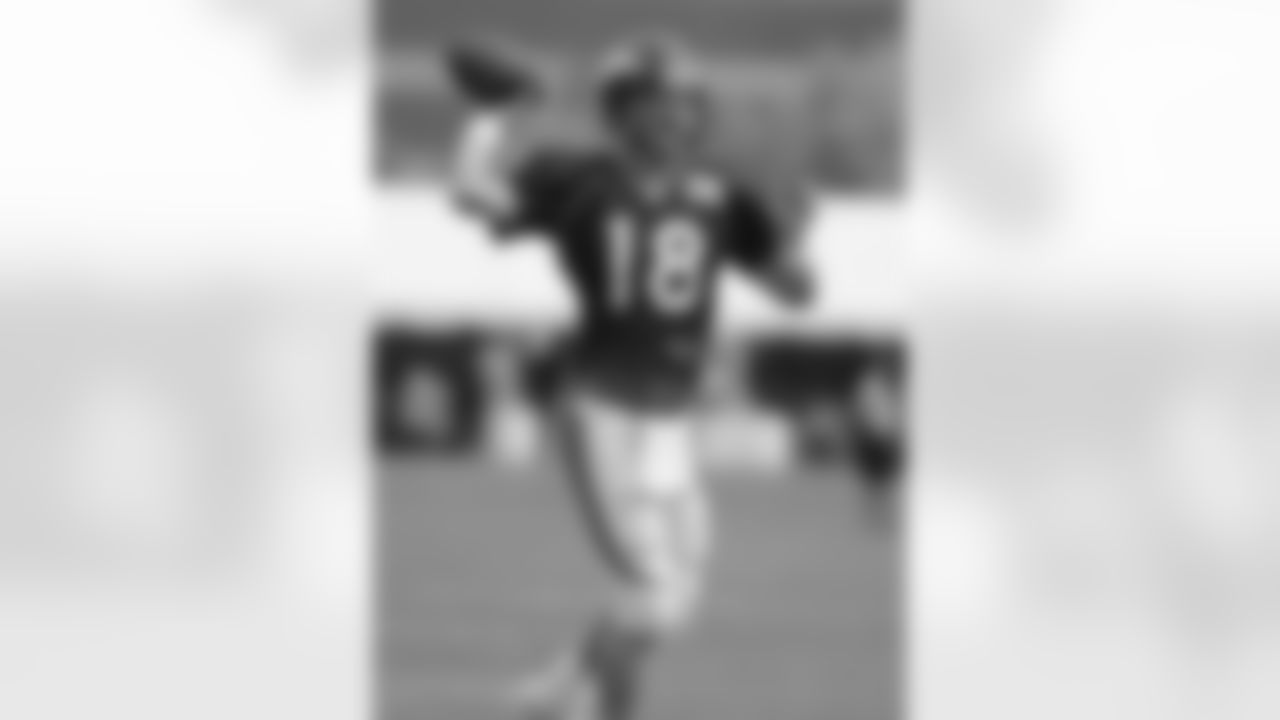 Manning throws a pass on the run.