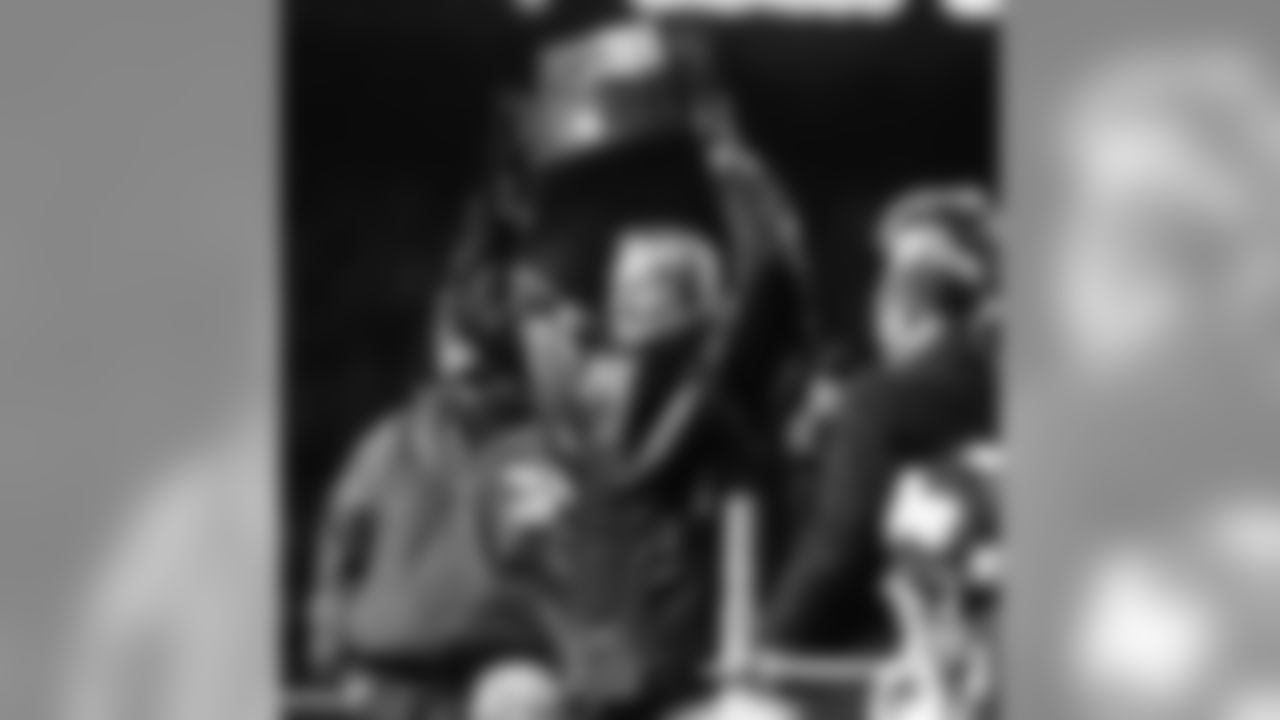 Pat Bowlen hoists another AFC Championship trophy up for the fans at Mile High to see against the New York Jets at Mile High Stadium in Denver, CO on January 17, 1999.