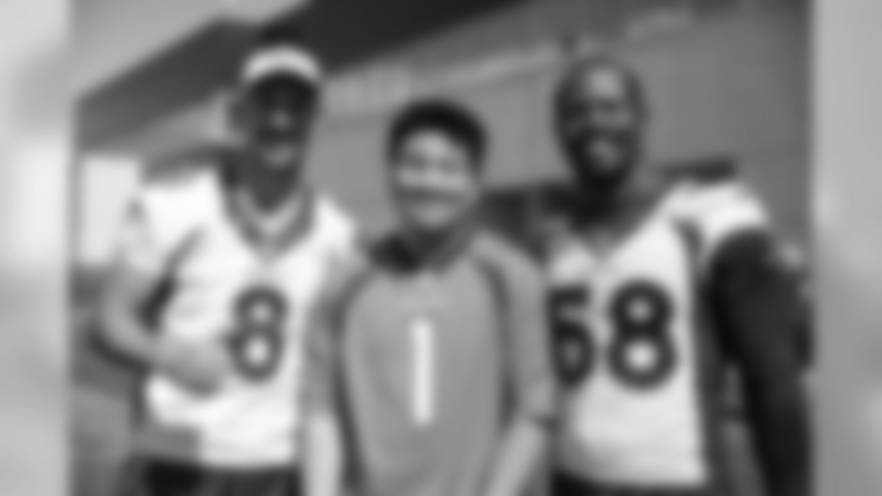 Brandon McManus and Von Miller take a photo with Marcus during a Make-A-Wish visit to UCHealth Training Center on September 27, 2019. (Photo by Ben Swanson)