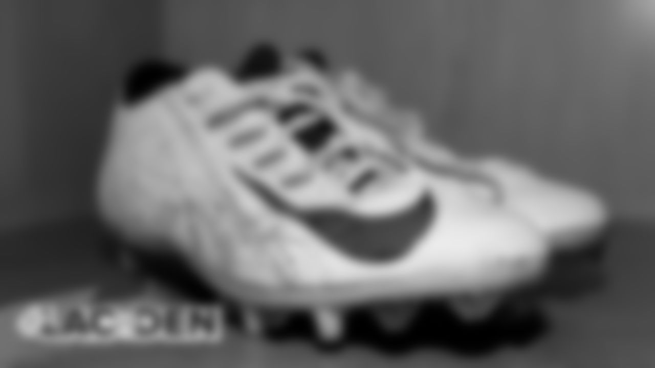 Phillip Lindsay's cleats in the locker room before the Broncos' game against the Los Angeles Chargers at Empower Field at Mile High on December 1, 2019. (Photo by Ben Swanson)