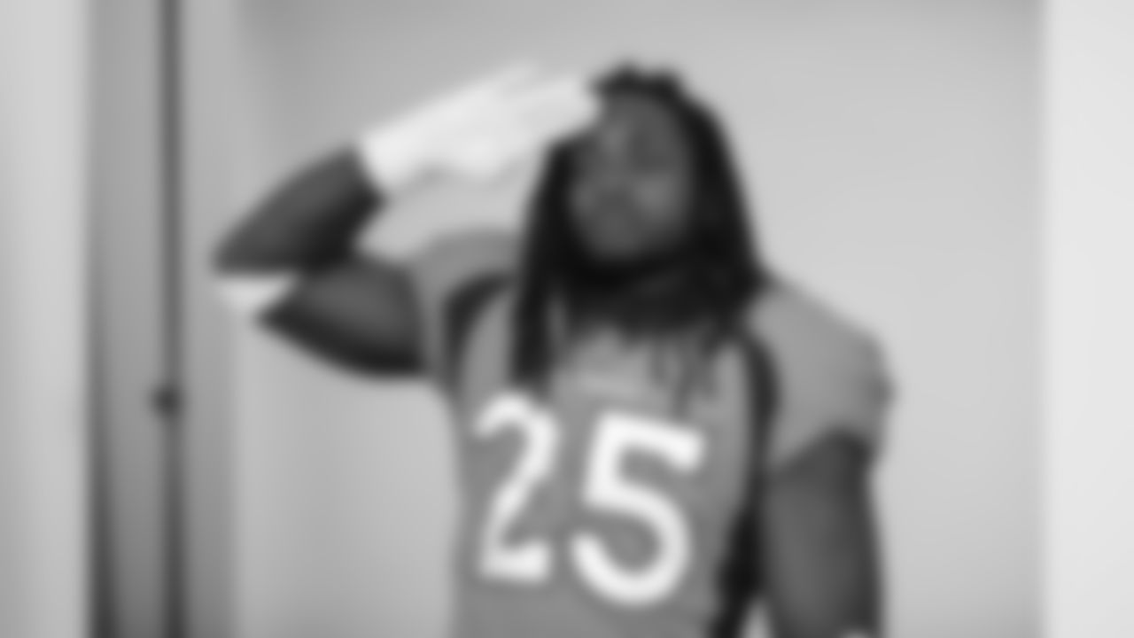 Melvin Gordon III gives a Mile High Salute during the team's annual media day photoshoots on August 2, 2020. (Photo by Ben Swanson)