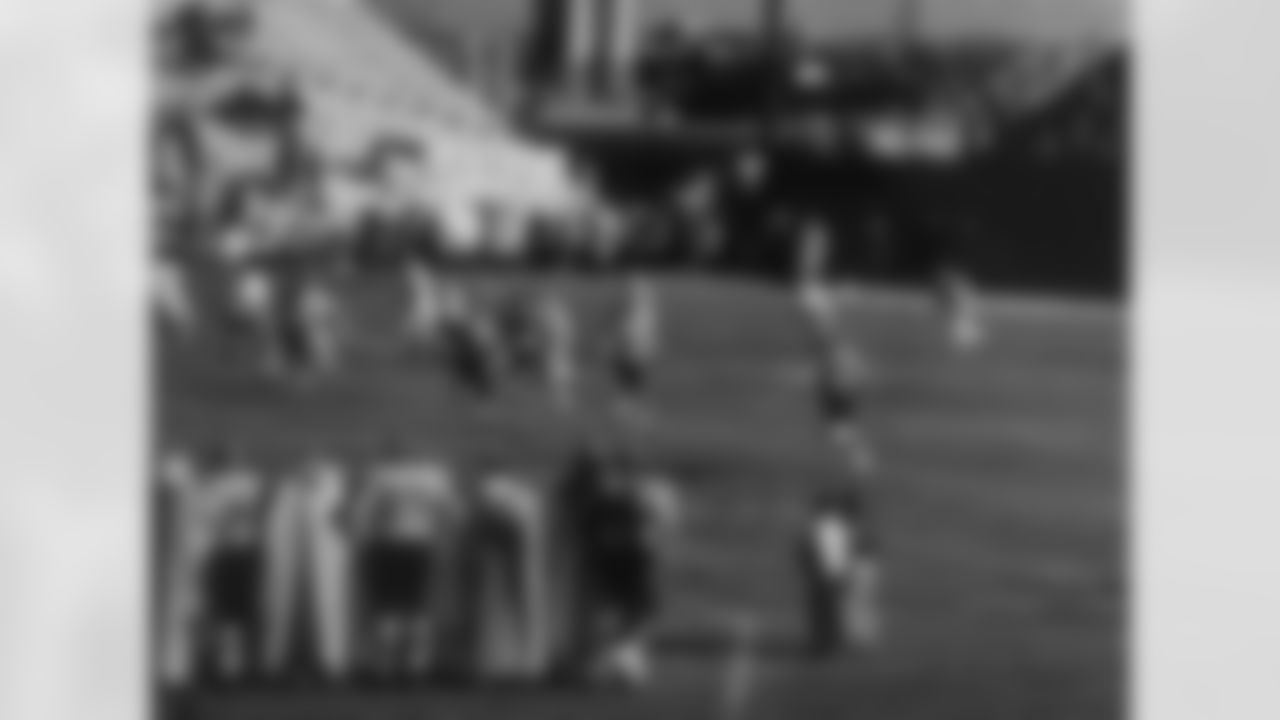 The Broncos' first uniforms featured brown helmets with a single white stripe down the middle and uniform numbers on the side. Pictured here is an early game at Bears Stadium in Denver in 1960 or 1961.