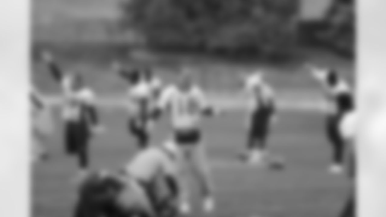 QB Peyton Manning gets loosened up before practice.