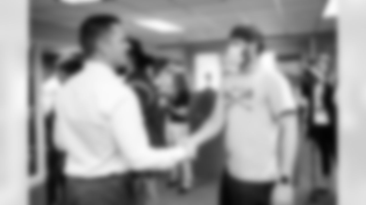 General Manager George Paton speaks with Broncos staff members during a visit to Empower Field at Mile High in Denver, Colorado on September 29, 2021. (Photo by Ben Swanson)