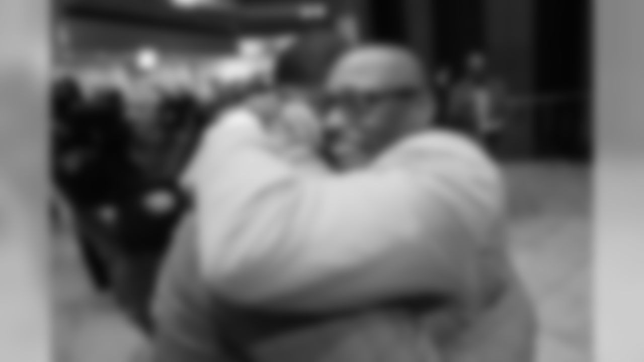 Floyd Little hugs Steve Atwater at the Pro Football Hall of Fame's Merlin Olsen Luncheon in Atlanta on February 1, 2019.