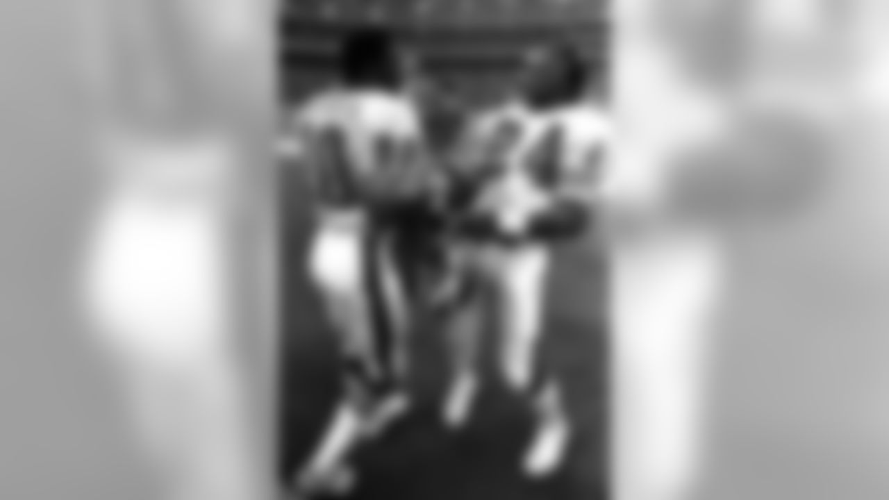 Rick Upchurch and Otis Armstrong laugh on the sideline. (Broncos photo archive)