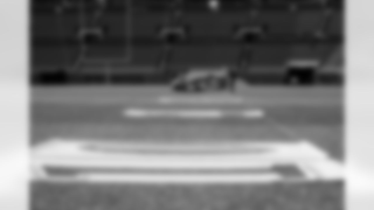 Members of the stadium's turf crew paint the field at Empower Field at Mile High on September 23, 2021 ahead of the team's Week 3 home opener. (Photo by Ben Swanson)
