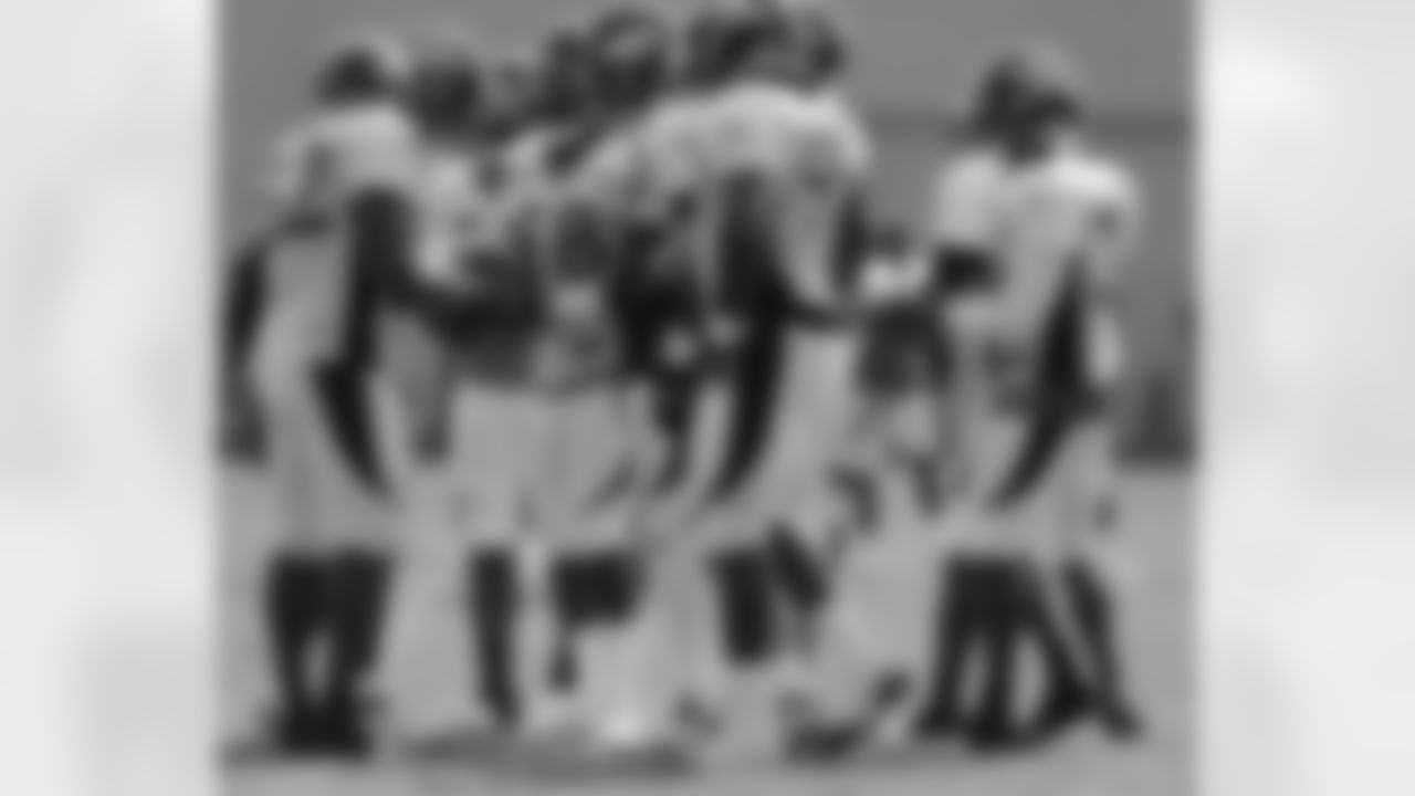 The Broncos defense huddles before a play.
