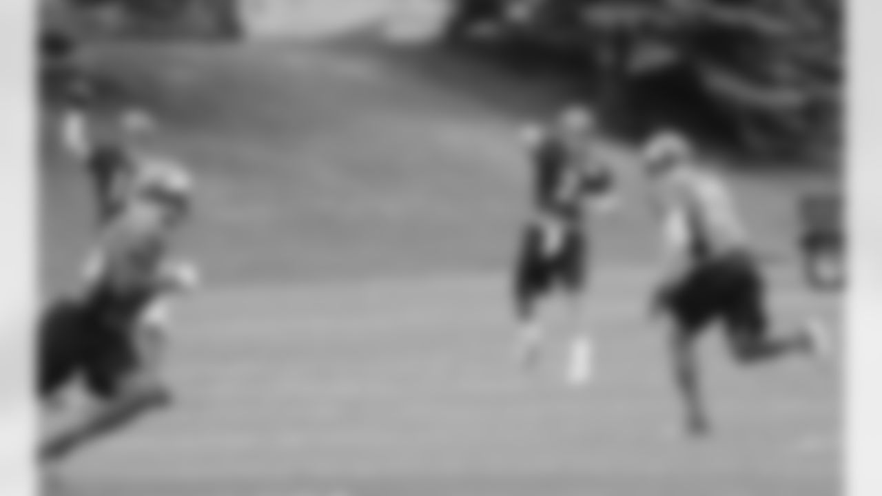 Manning and QB Adam Weber throw passes during practice.