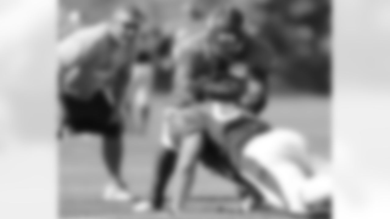 DE Elvis Dumervil sheds a cut block from DE Ben Garland.
