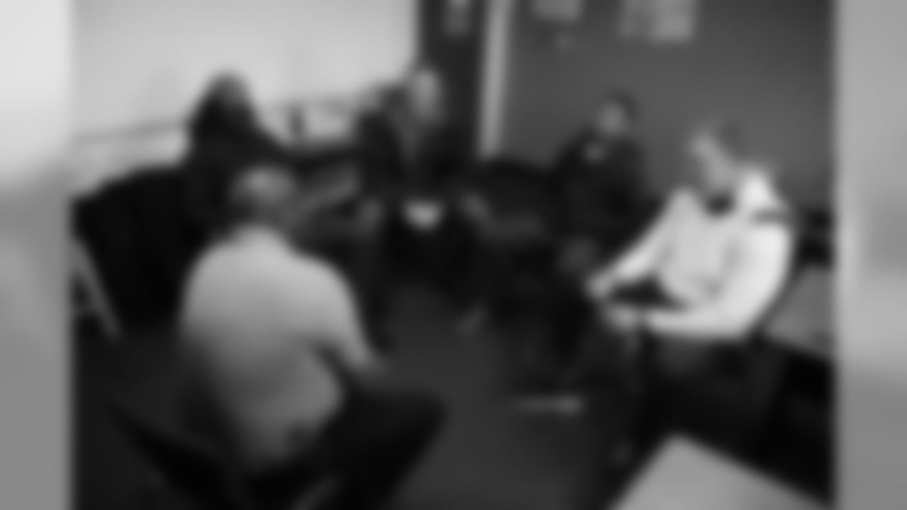 Isaac Yiadom, Andrew Beck and Khalfani Muhammad and Garett Bolles talk with technician Tyrone Campbell during an immersive training experience at the Denver Police Academy on October 28, 2019. (Photo by Ben Swanson)