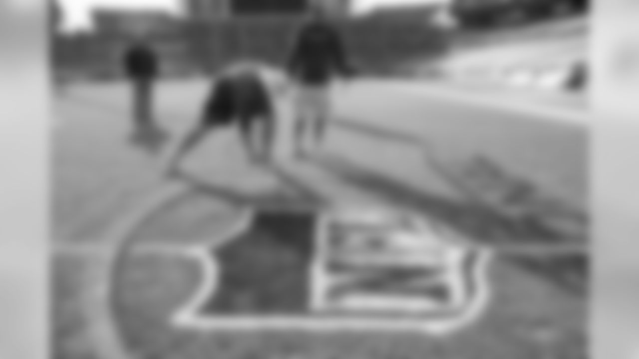 The grounds crew gets the field ready for Saturday's Divsional Round game.