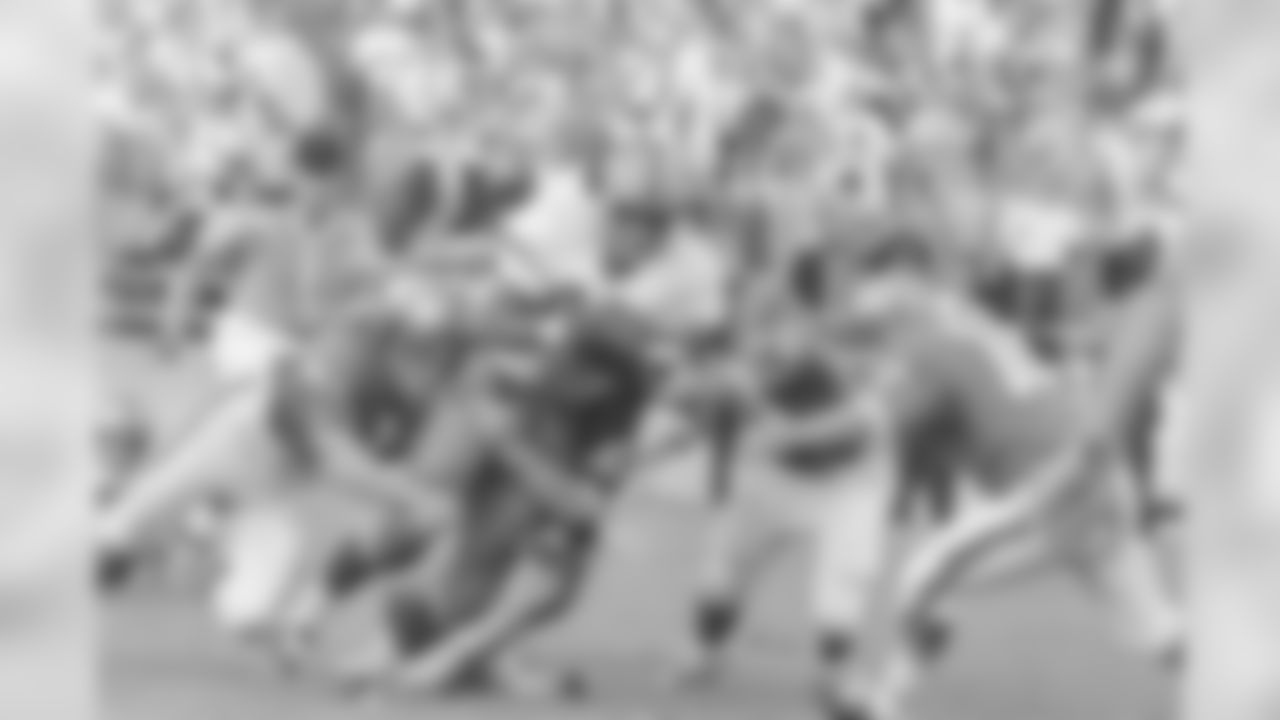 Syracuse Orangemen's Floyd Little (44) keeps charging down the field despite efforts of Baylor's Willie Walker (83) and Paul Ortiz (30) trying to stop the hard running halfback during third quarter of their game on Sept. 12, 1966 at Baylor Stadium in Waco, Texas. Coming in to assist on the play are O.B. Goolsby (50) and Bob Purvis (18). Baylor won the non-conference game, 35-12. (AP Photo/FK)