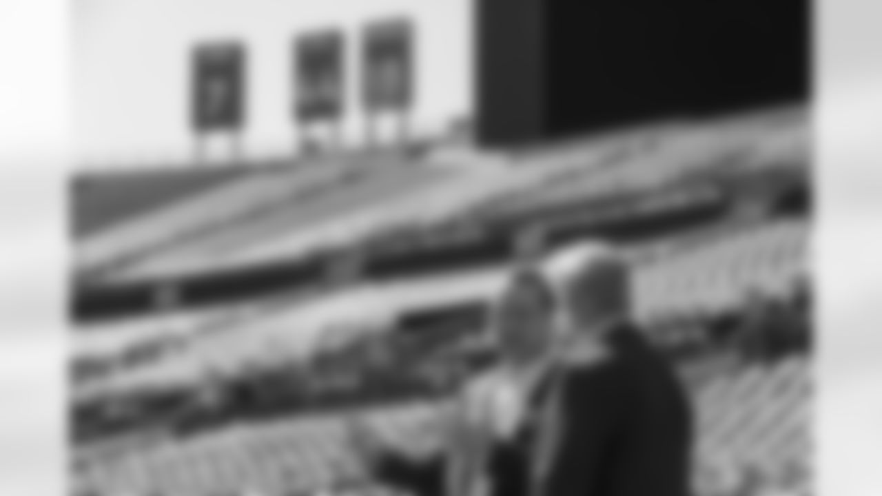 Peyton Manning conducts an interview with John Elway during the taping of an episode of Peyton's Places at Empower Field at Mile High on June 26, 2020. Signage recognizing the Broncos' retired numbers for Elway, Manning, Floyd Little and Frank Tripucka sits atop the south stands behind them. (Photo by Ben Swanson)