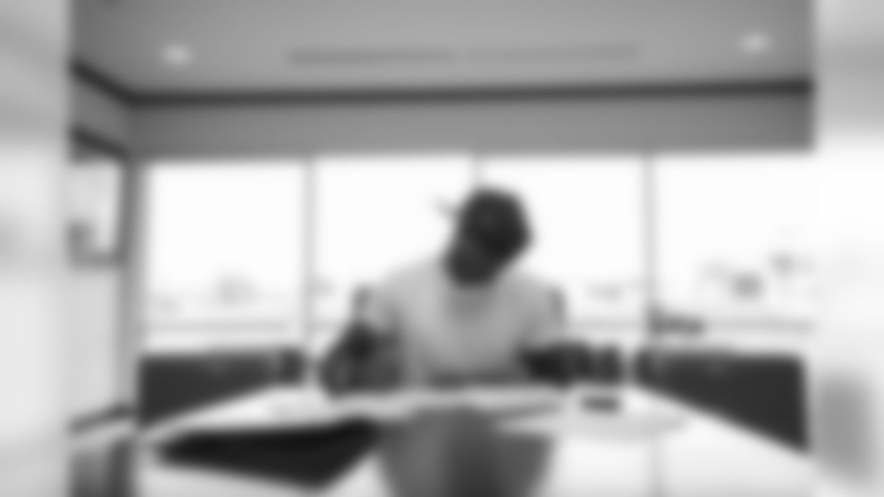 KJ Hamler signs his rookie contract in Pat Bowlen's conference room at UCHealth Training Center on July 27, 2020. (Photo by Ben Swanson)
