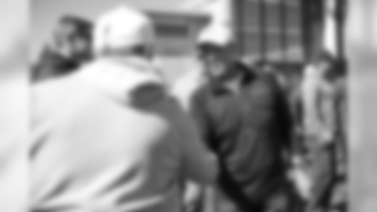 Head Coach Vic Fangio greets Jim Ryan as Broncos alumni watch the team's walkthrough and meet with current players and coaches afterward on October 12, 2019. (Photo by Ben Swanson)