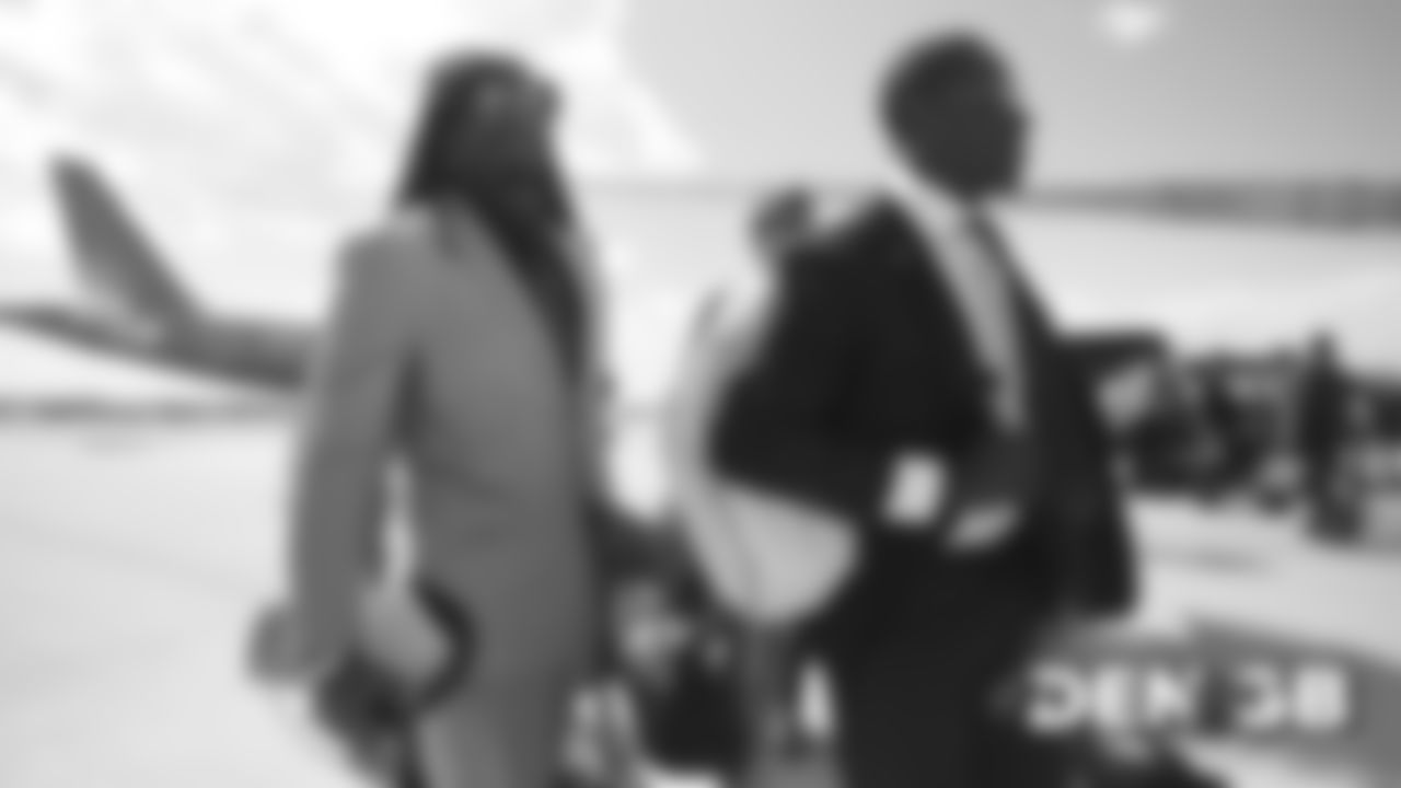 Alexander Johnson and Joe Jones on the tarmac at Denver International Airport during the team's travel to Wisconsin on September 8, 2019 ahead of their Week 3 game against the Green Bay Packers. (Photo by Ben Swanson)
