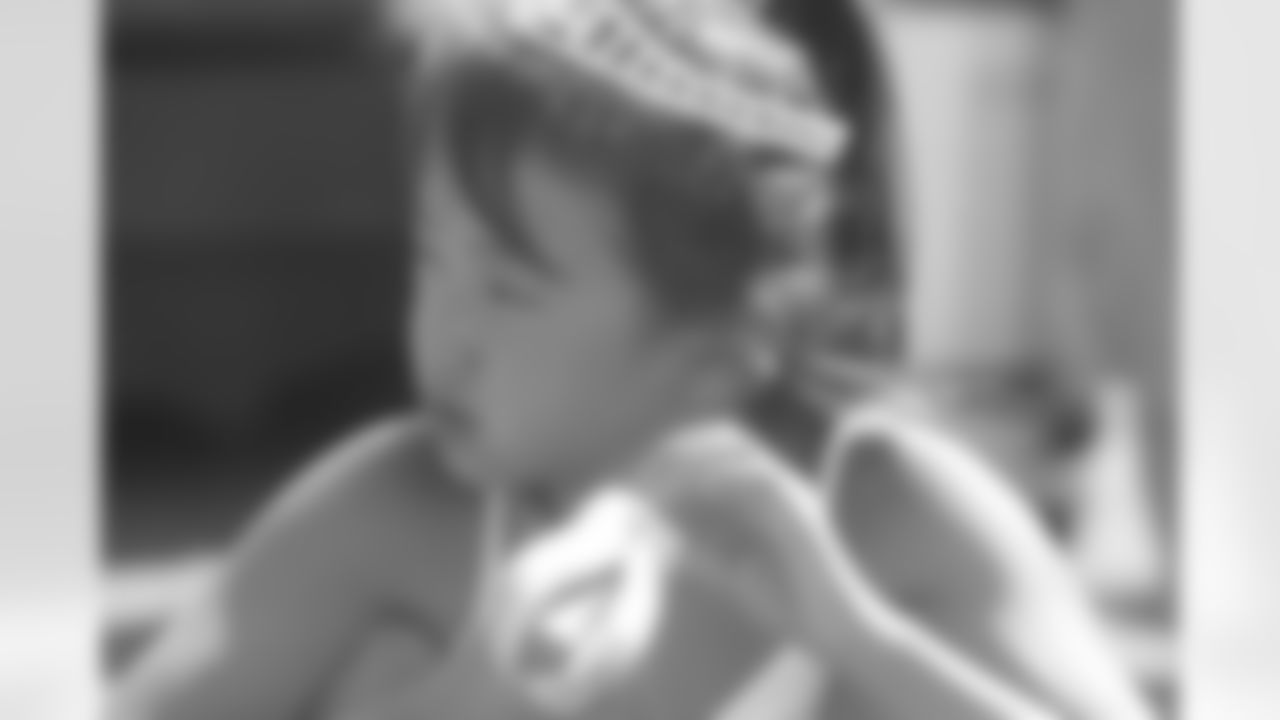 A young fan enjoys the race and a hot dog.