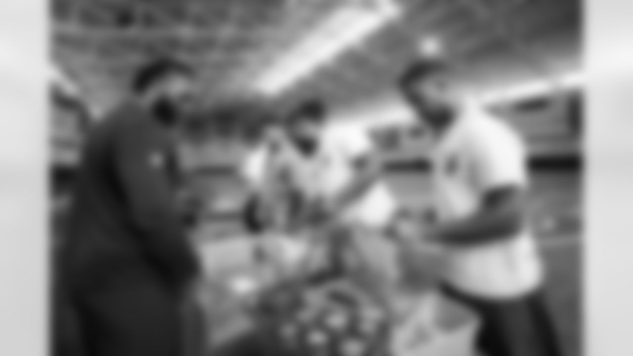 Baron Browning, McTelvin Agim and Donnie Lewis Jr. at an event packaging mental health supplies for local groups at UCHealth Training Center in Englewood, Colorado on May 24, 2022. (Photo by Ben Swanson)