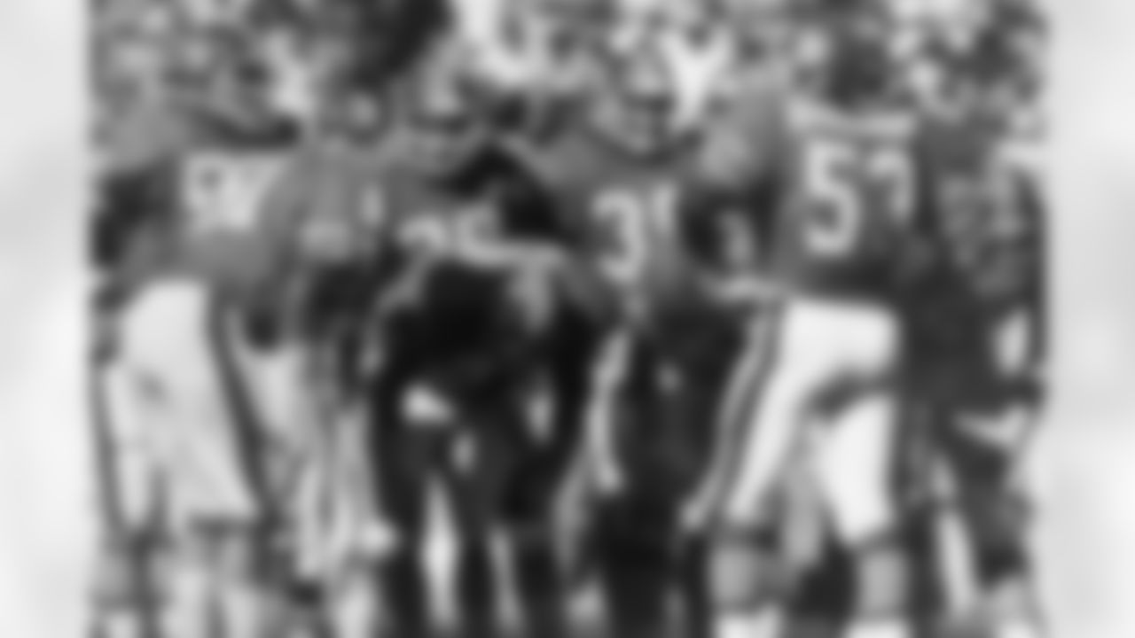 Linebacker Bob Swenson, defensive end Lyle Alzado, linebacker Randy Gradishar and the rest of the Orange Crush defense huddle up before a play at Mile High Stadium.