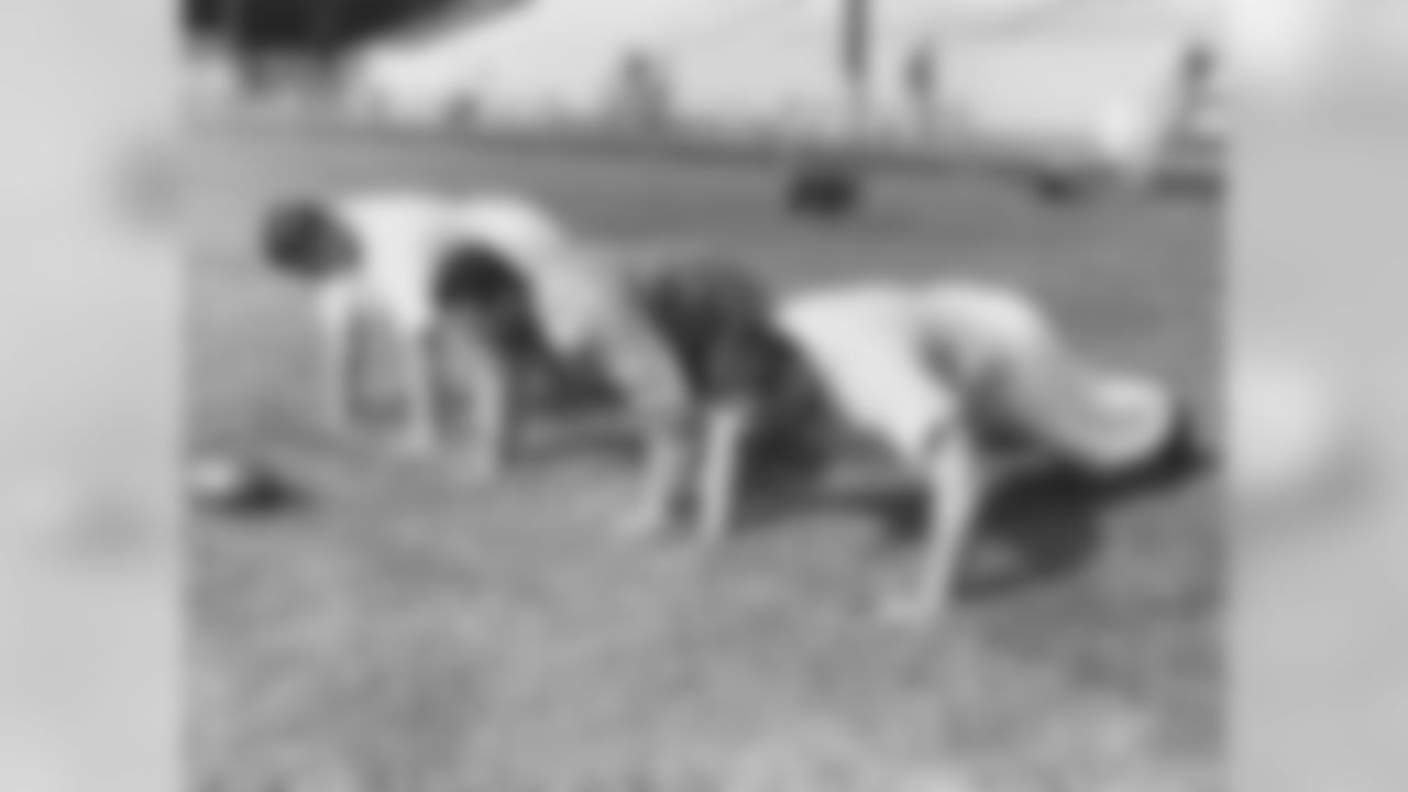 Dante Lavelli, Don Colo and Lou Groza crank out some pushups in 1955.