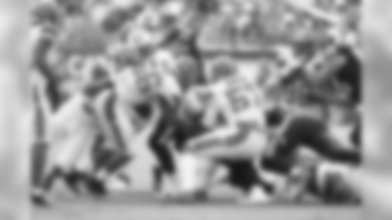 LBs Demario Davis (56) and Cam Johnson (57) make a tackle.