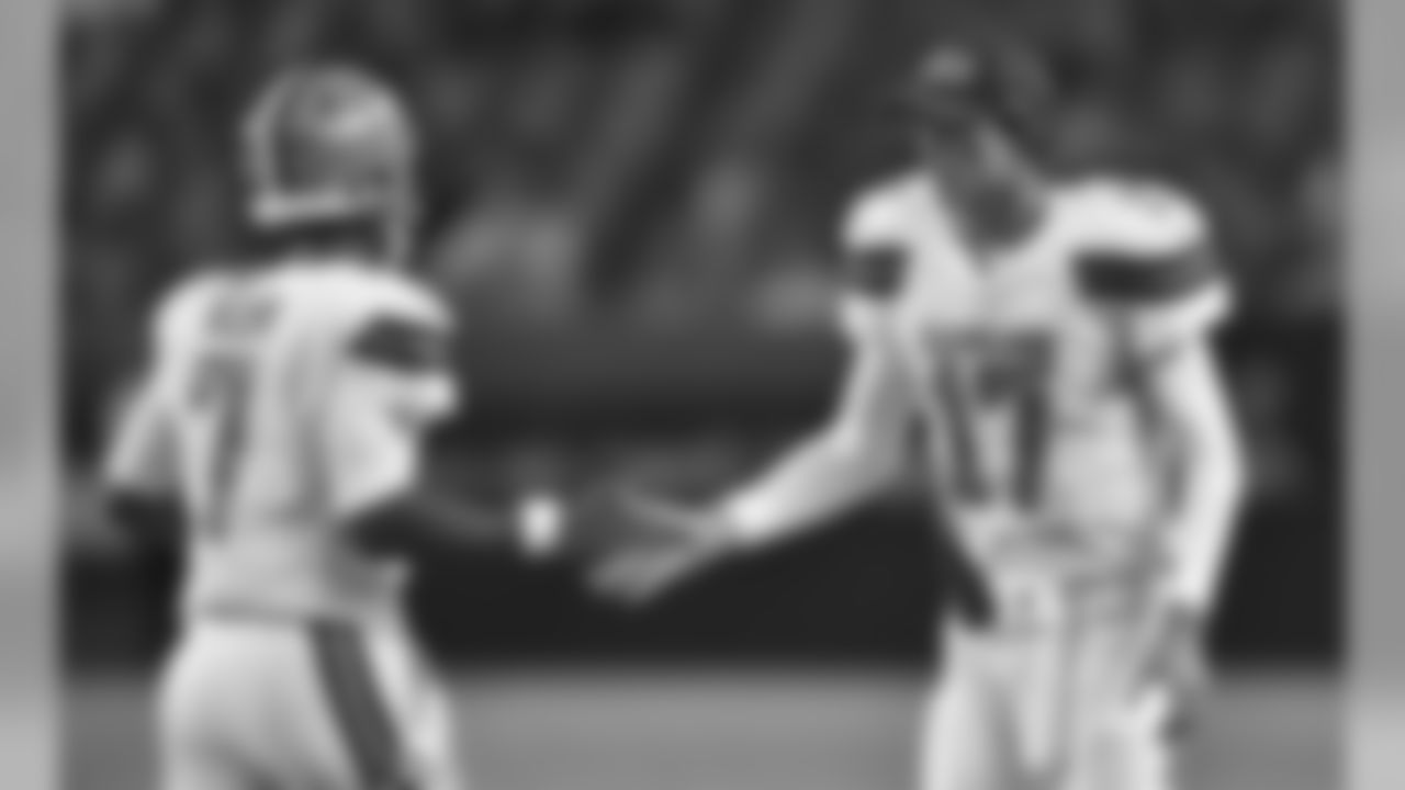 QB Brock Osweiler (right) congratulates QB DeShone Kizer (left) on a touchdown play.