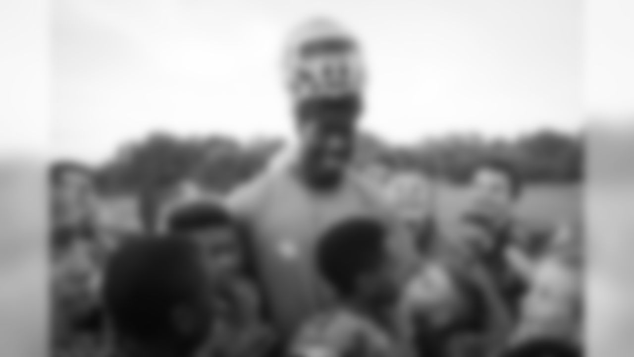 Johnson Bademosi hanging out with Brooklyn Hurricanes youth football players on Tuesday. Bademosi and five of his teammates surprised the youth football team at their practice.