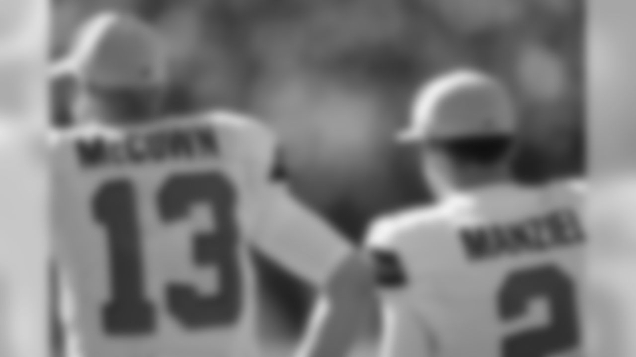 Cleveland Browns quarterbacks Josh McCown and Johnny Manziel stand next eachother on the sidelines