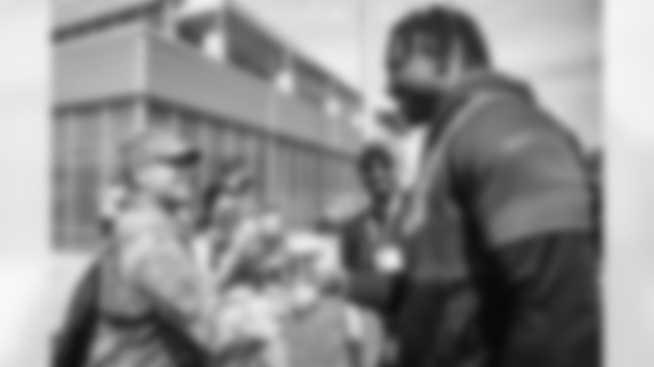 Defensive end Myles Garrett (95) and members of the military during the seventh day of training camp at CrossCountry Mortgage Campus on August 3, 2022.