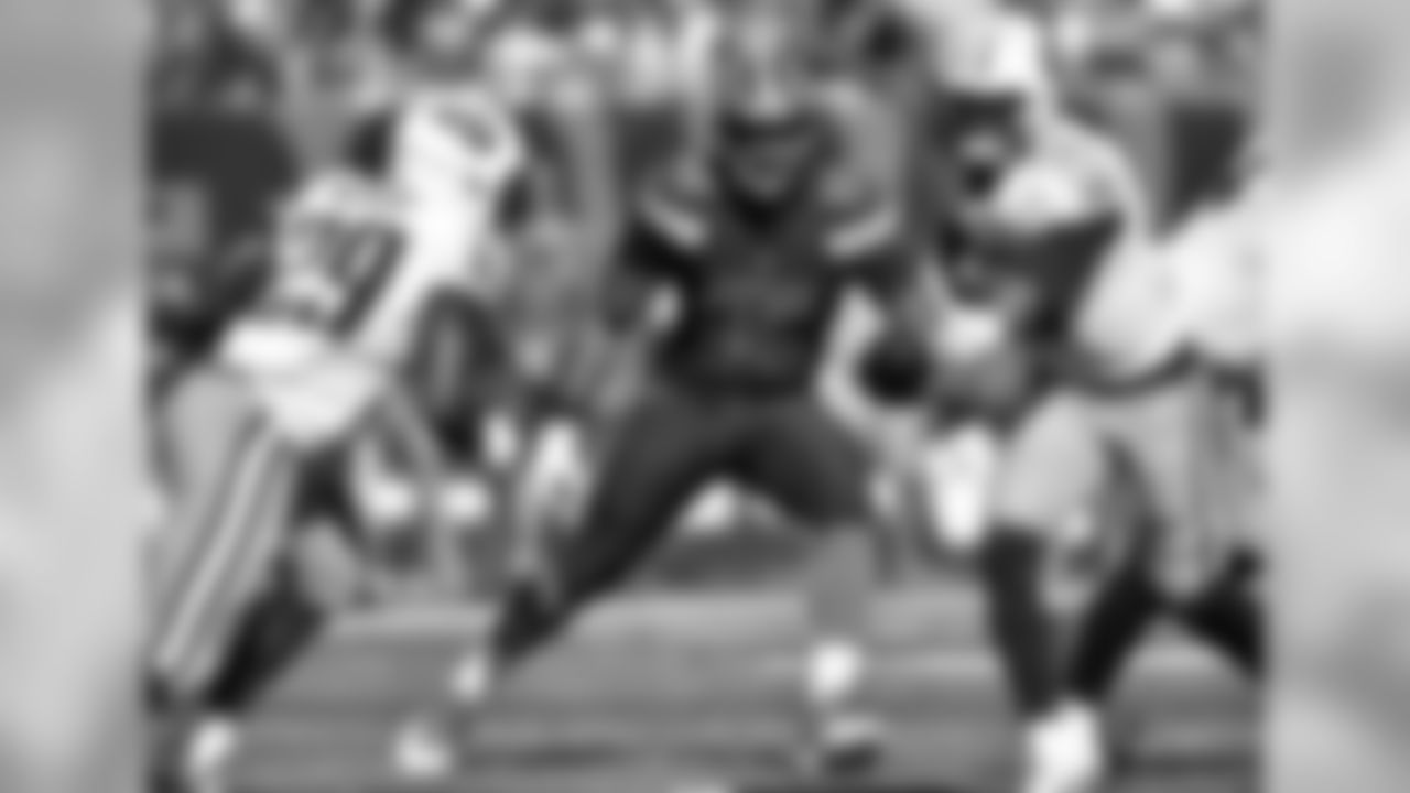 DL Myles Garrett pressures Titans QB Marcus Mariota.