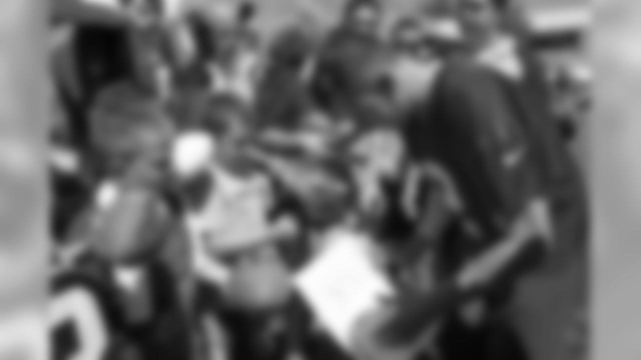 QB Johnny Manziel signs autographs for fans after practice.