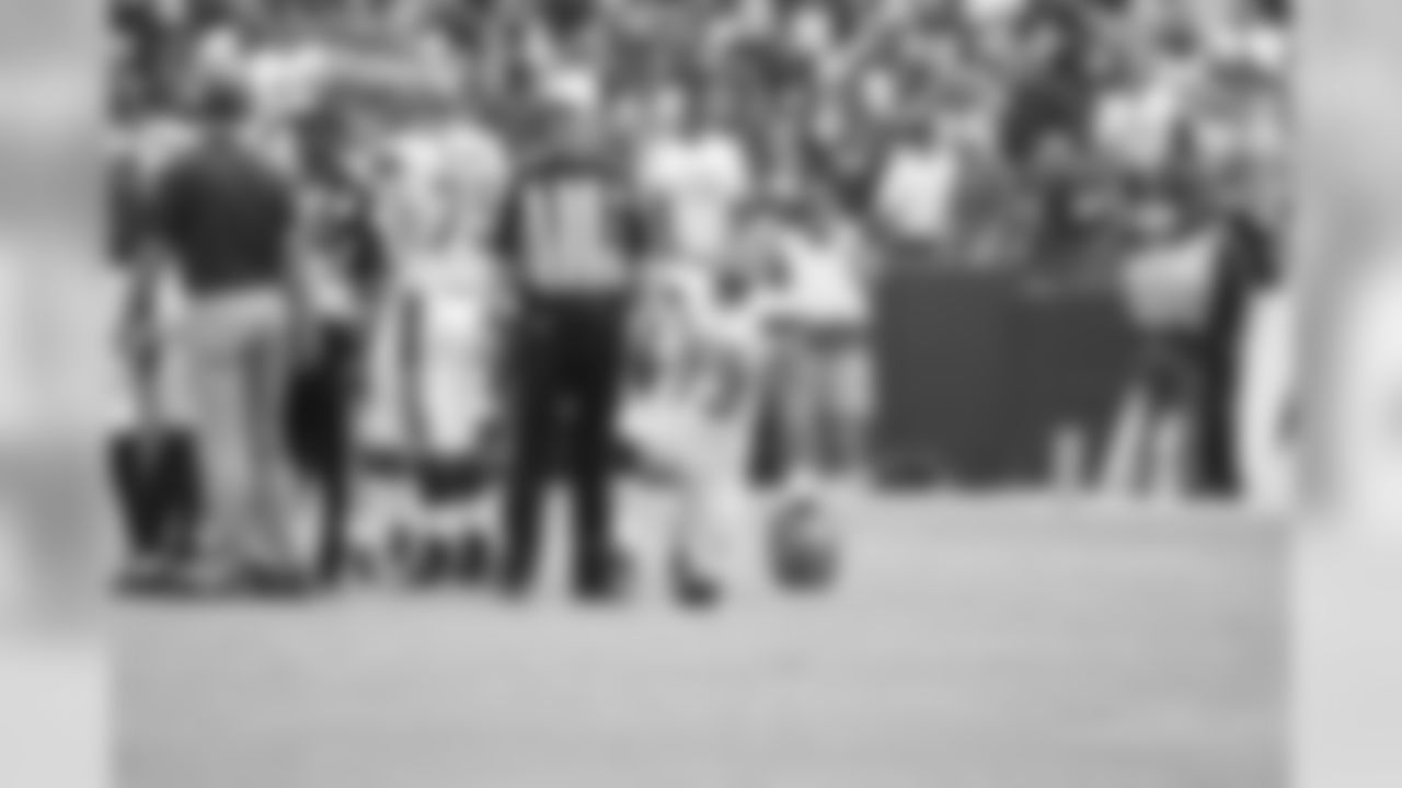OL Joe Thomas takes a knee on the field.