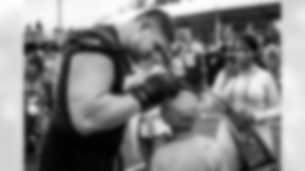 Offensive guard Wyatt Teller (77) signs autographs for fans during the twelfth day of training camp at CrossCountry Mortgage Campus on August 14, 2022.