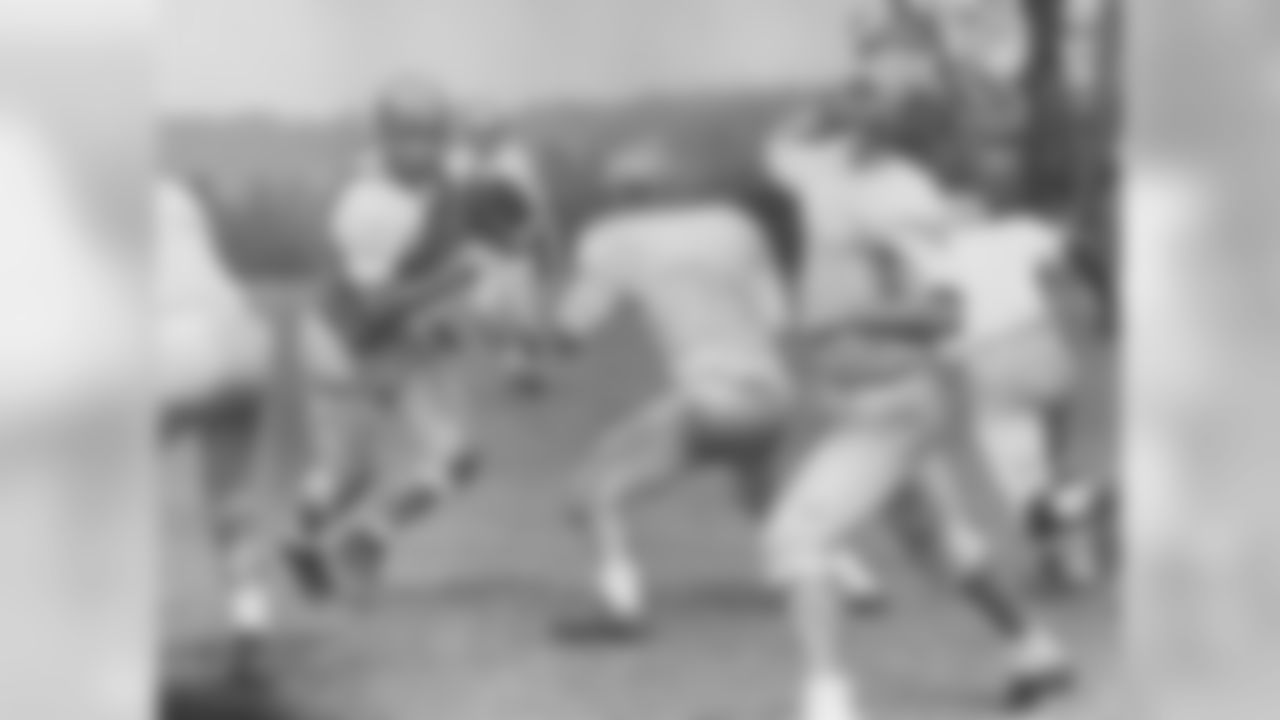 Bob Gain rushes Gene Hickerson and Milt Plum during a drill in 1960.