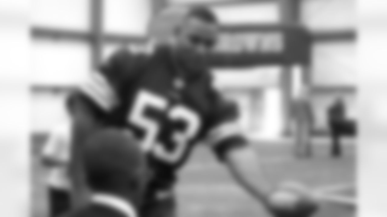 Cleveland Browns Alumni John Thierry (1999) hands off to a Special Olympics participant