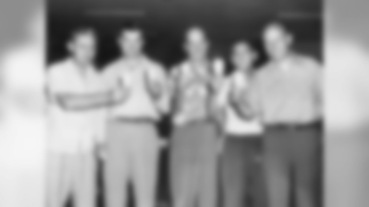 Coaches Paul Bixler, Ed Ulinski, Paul Brown, Fritz Heisler and Howard Brinker take an ice cream break during training camp in 1954.