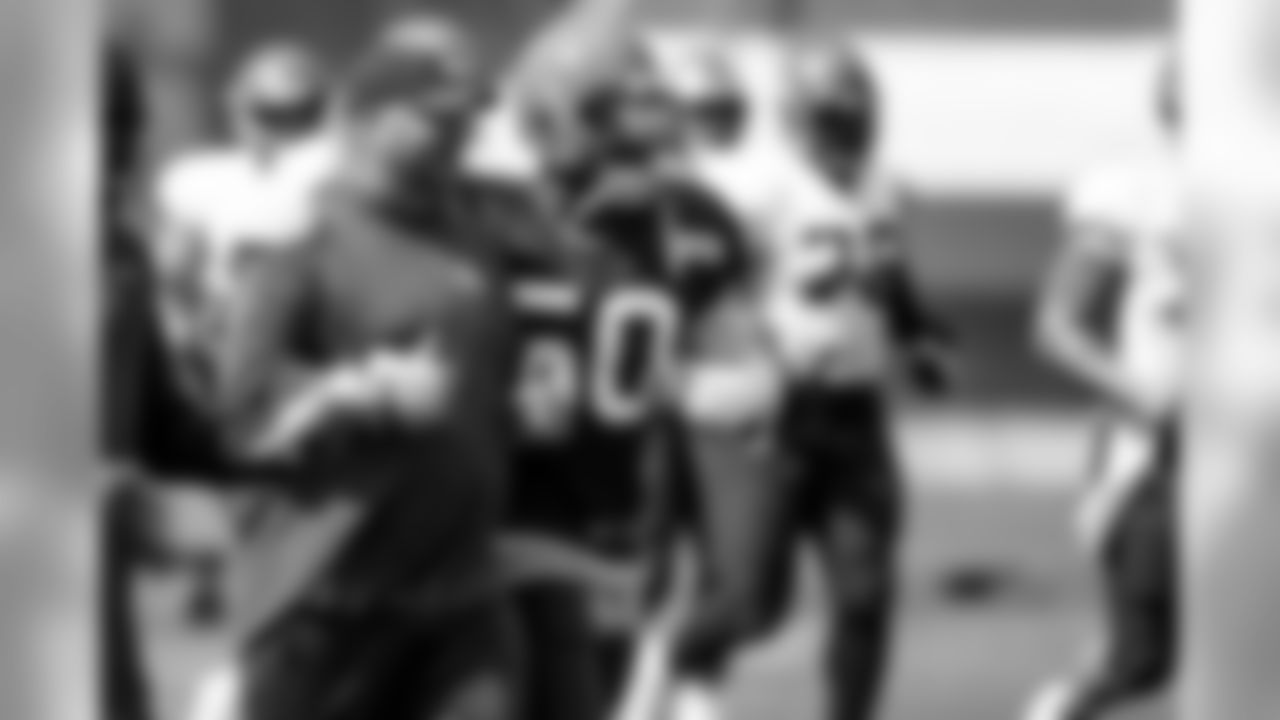 Head Coach Freddie Kitchens and Defensive end Chris Smith (50) during the seventh day of training camp on August 1, 2019.