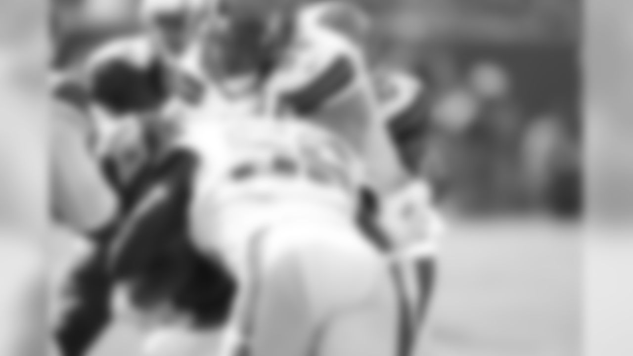LB Demario Davis (56) and DL Jamie Meder (98) make a tackle.
