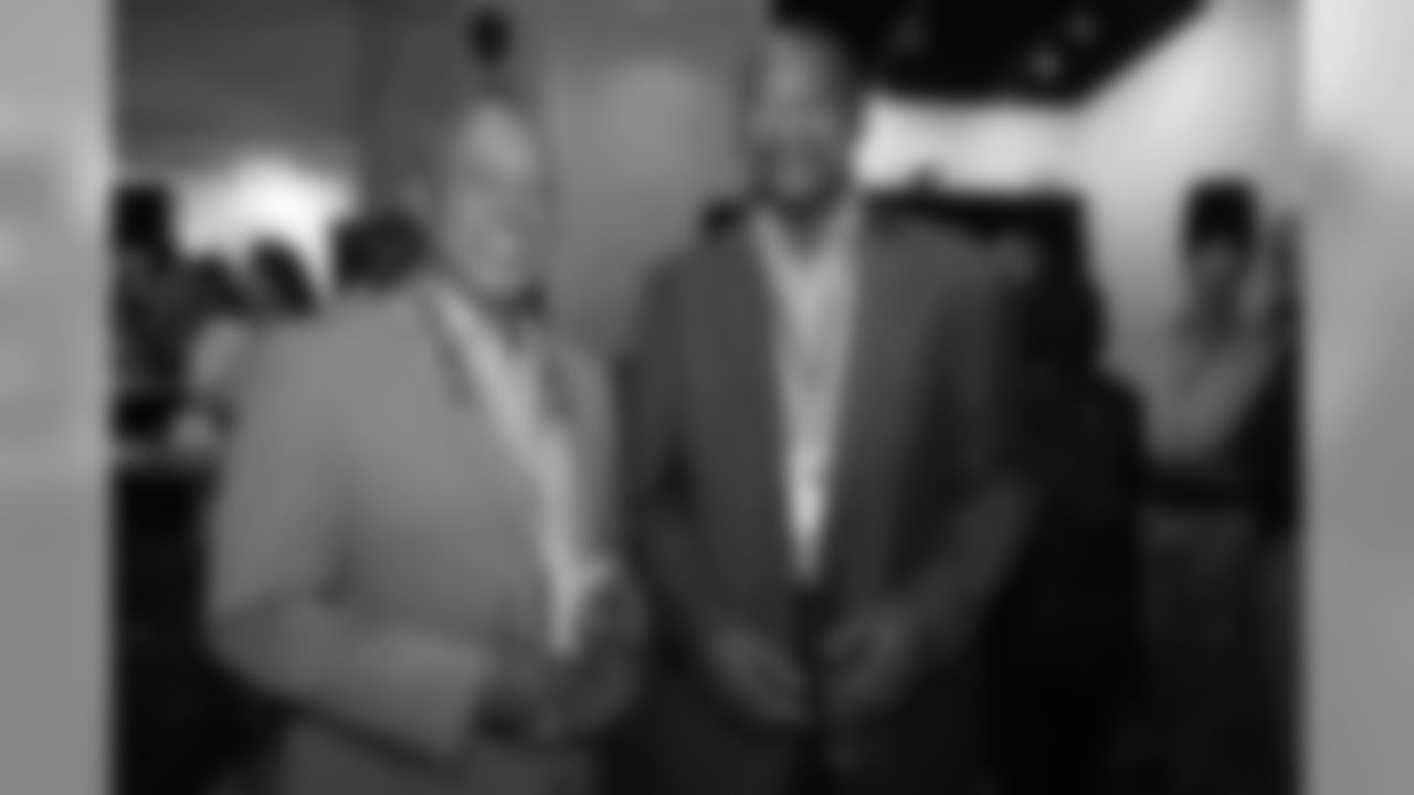Former Cleveland Browns Cornerback Ben Davis, left, and former Defensive Back Erich Barnes, right, pose for a photo.