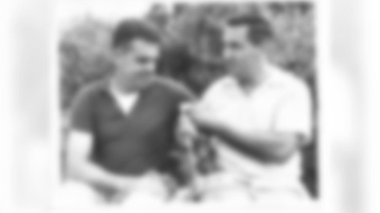 Otto Graham and Lou Groza preparing their clubs for battle