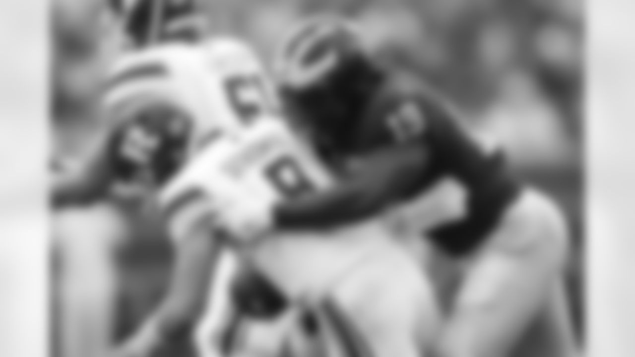FILE - In this Saturday, Sept. 28, 2019, file photo, Michigan defensive lineman Kwity Paye (19) sacks Rutgers quarterback Artur Sitkowski (8) in the first half of an NCAA college football game, in Ann Arbor, Mich. Michigan has been good, not great, under coach Jim Harbaugh. Michigan defensive end Kwity Paye said the 19th-ranked team is under the radar and the Wolverines have taken a lot of punches from people, criticizing the relatively underwhelming state of the program. (AP Photo/Paul Sancya, File)