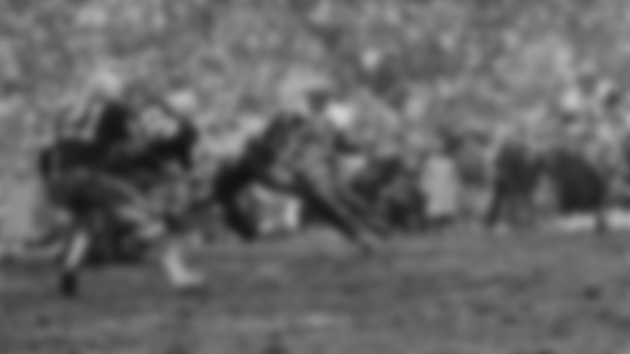 Cleveland fullback Jimmy Brown (32) turns the corner as a Green Bay Packer defender swings with him, Jan. 2, 1966, Green Bay, Wisc. Brown gained short yardage on the play. At left is Packer linebacker Lee Roy Caffey. Brown was held to 50 yards in 12 carries as Green Bay won 23-12. (AP Photo)