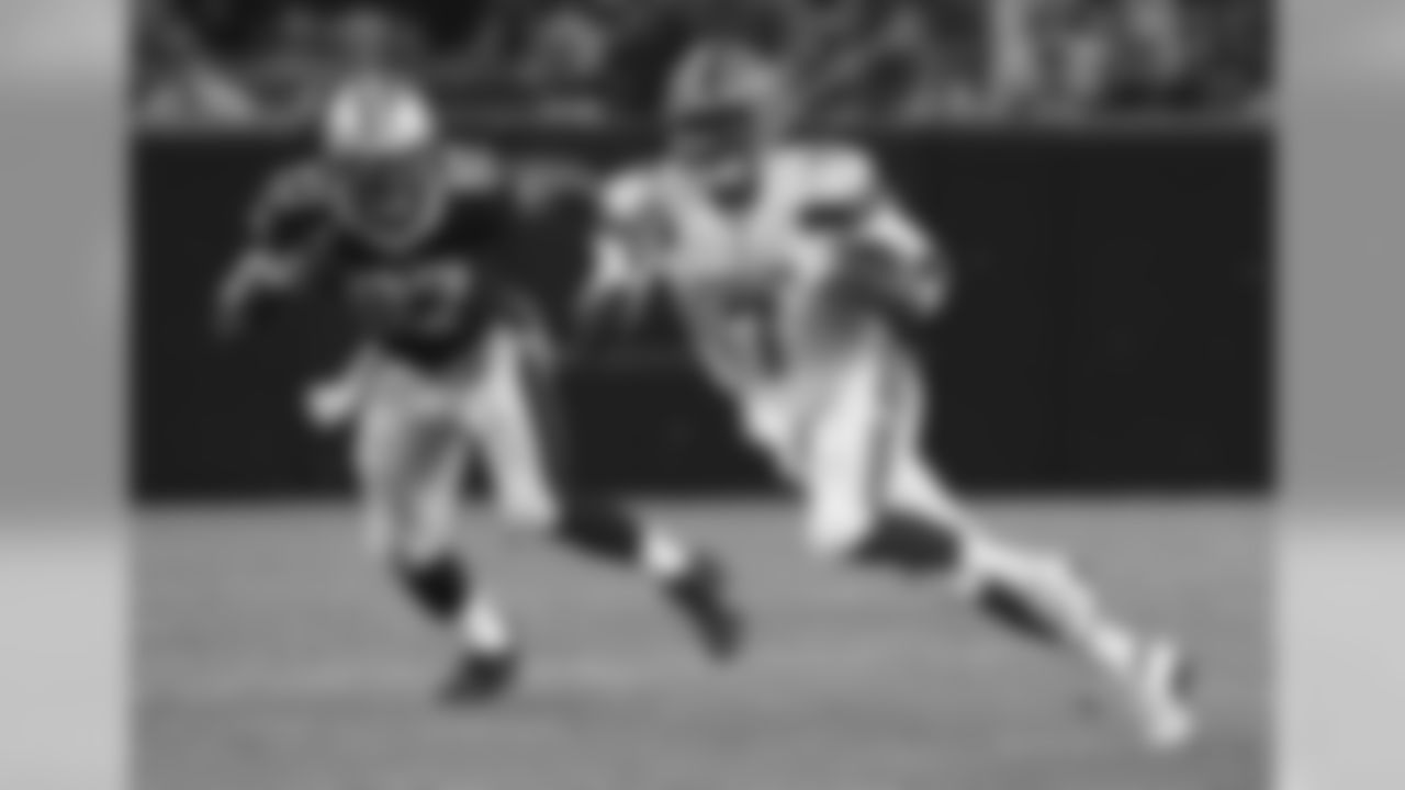 QB DeShone Kizer runs from New Orleans Saints DE Al-Quadin Muhammad.