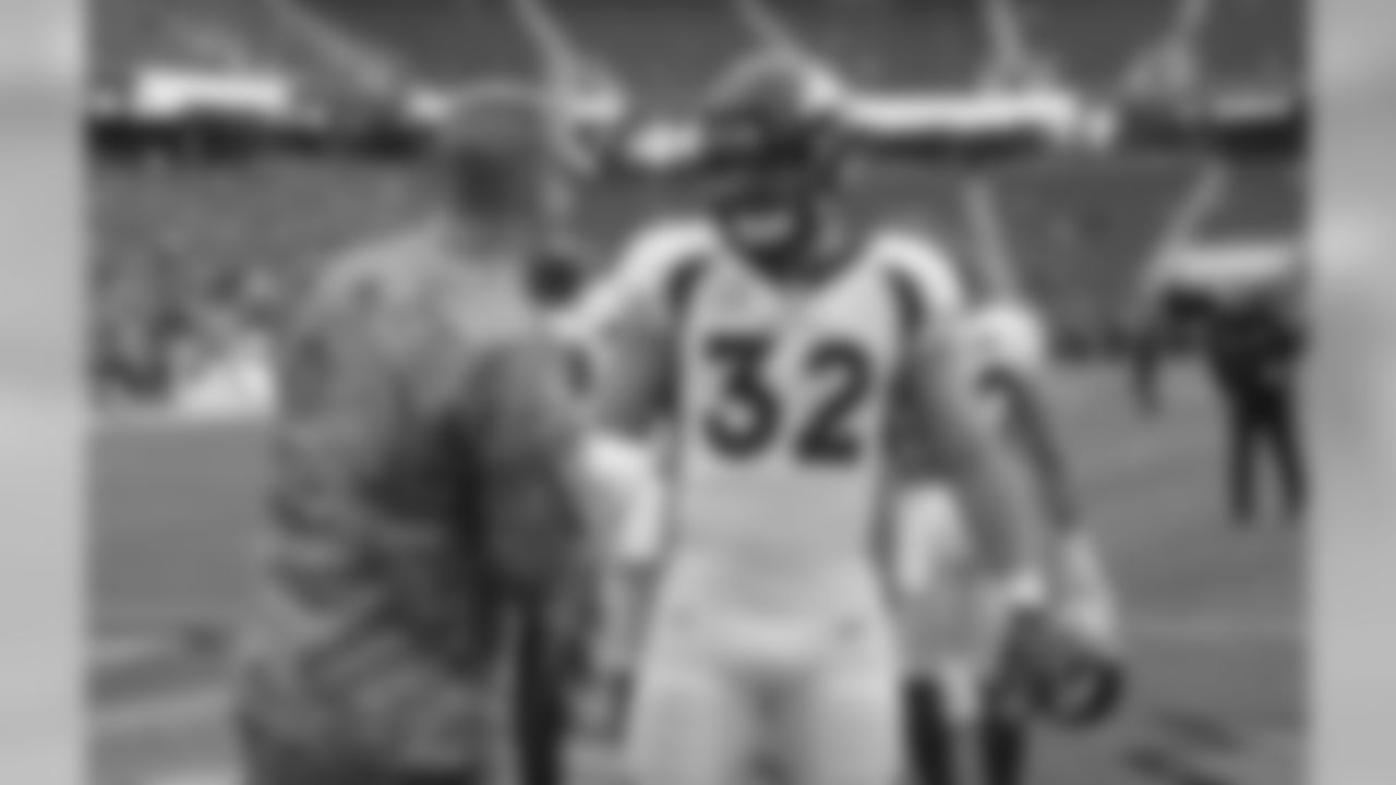 Denver Broncos fullback Andy Janovich visits with an armed services member before the start of an NFL football game against the San Francisco 49ers Sunday, Dec. 9, 2018, in Santa Clara, Calif. (AP Photo/Josie Lepe)