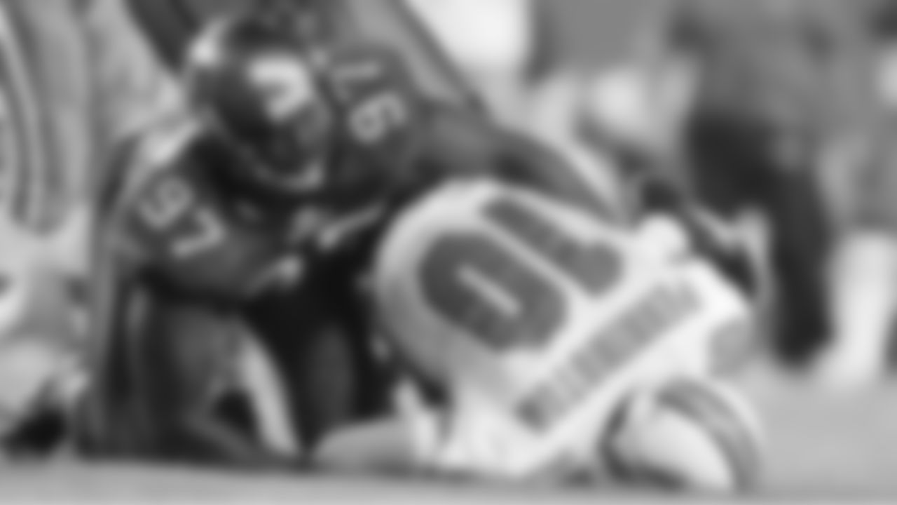 97 DE Jimmy Wilkerson prepares to get up after notching a first-quarter sack of Miami QB Chad Pennington
