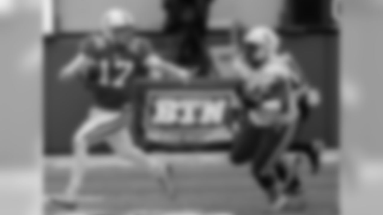 Nebraska red team quarterback Ryker Fyfe (17) runs away from white team defensive lineman Khalil Davis (94) during the annual NCAA college football Red White spring game in Lincoln, Neb., Saturday, April 16, 2016. (AP Photo/Nati Harnik)