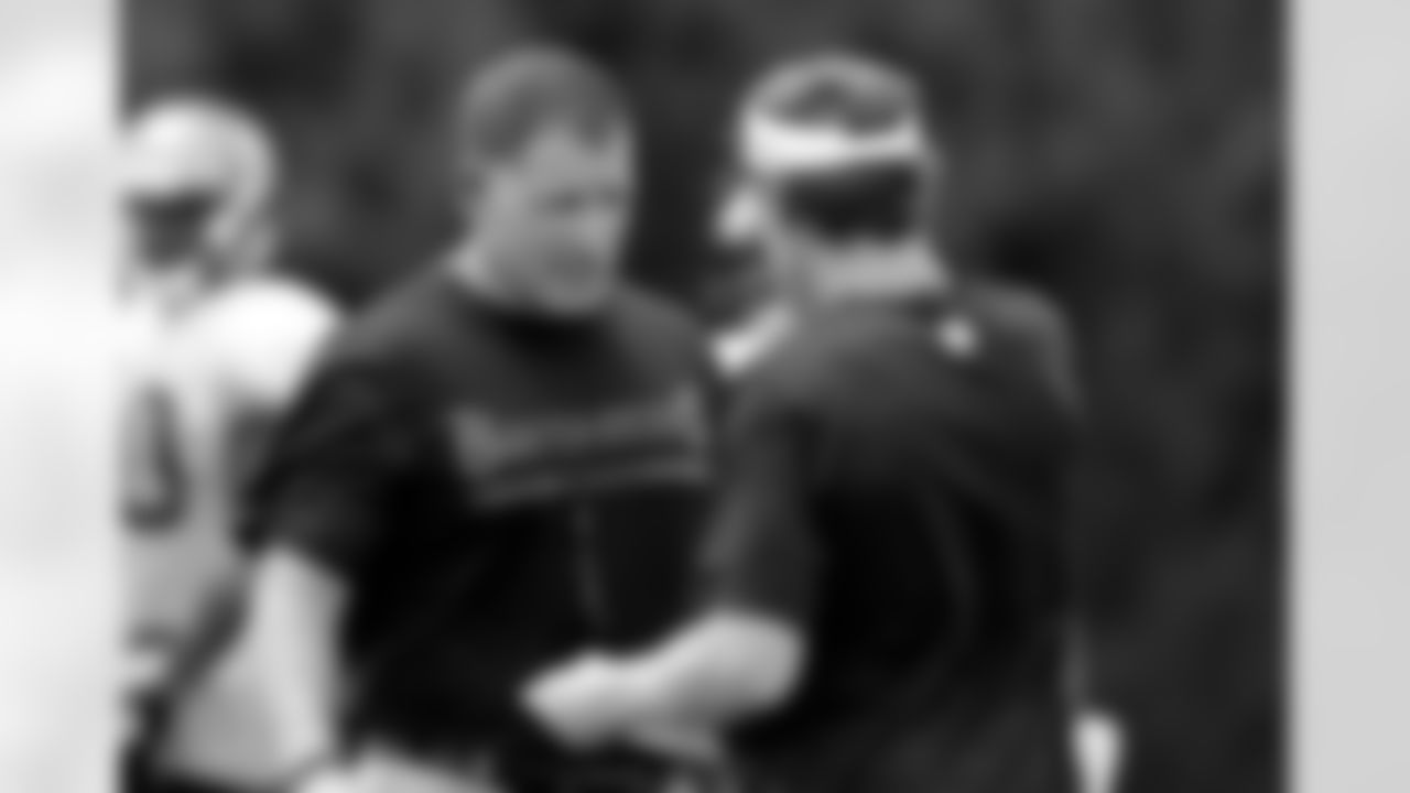 Head Coach Greg Schiano talks to Wide Receivers Coach John Garrett.