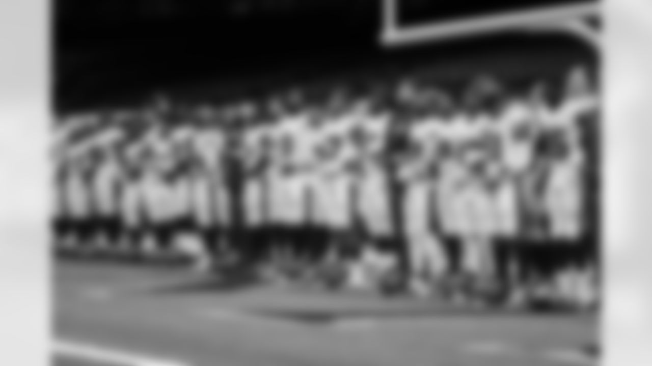 Buccaneers players and coaches stand in unity prior to Bucs vs. Saints, Week One
