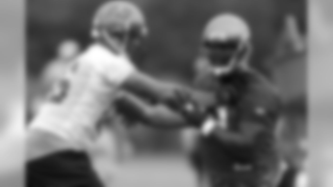 TE Jerramy Stevens tries to keep DE Kevin Carter at arm's length